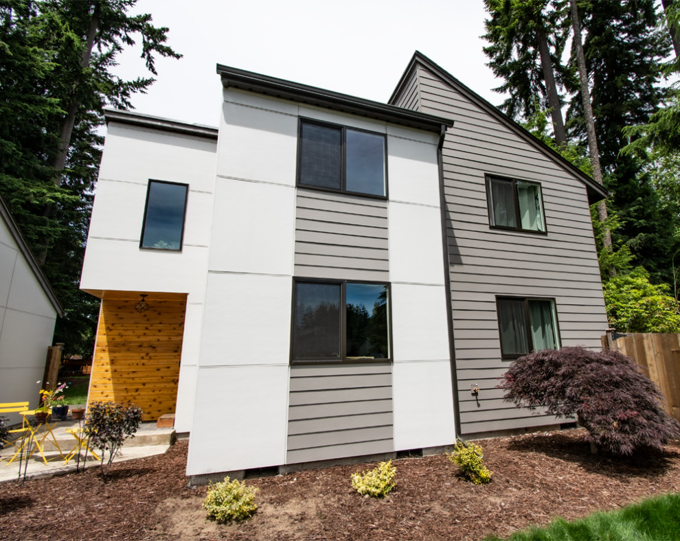 Mid-sized modern gray two-story concrete fiberboard and board and batten house exterior idea