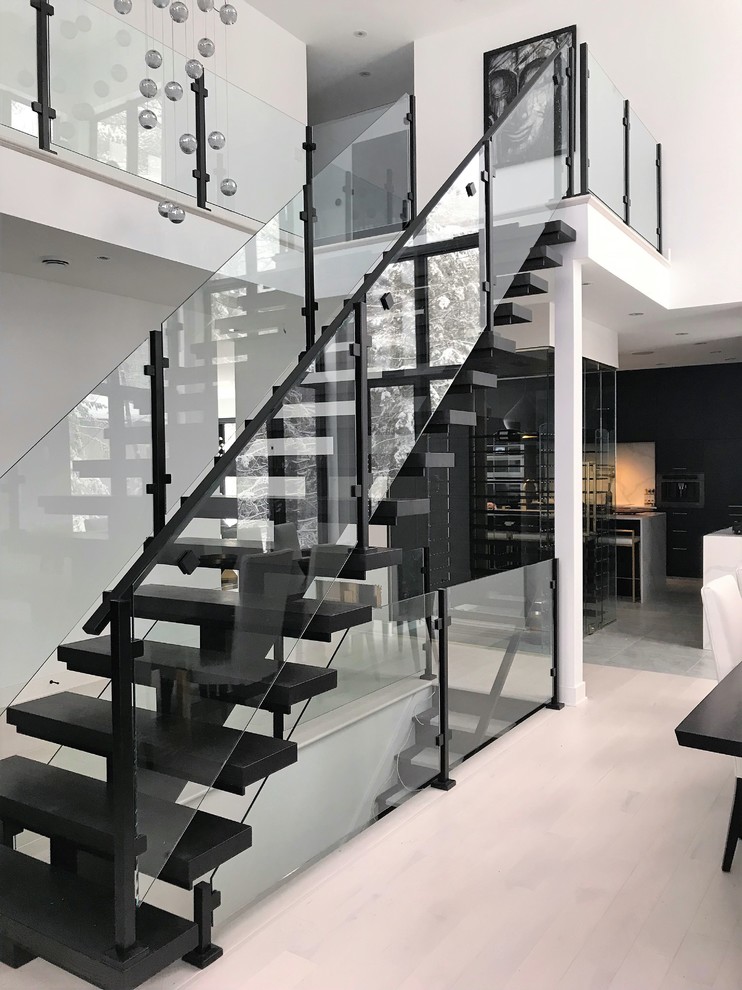 Design ideas for a contemporary staircase in Montreal with glass railing.
