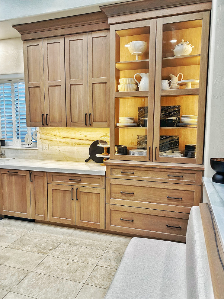 Large country u-shaped ceramic tile and beige floor enclosed kitchen photo in Phoenix with an undermount sink, shaker cabinets, medium tone wood cabinets, quartzite countertops, beige backsplash, stainless steel appliances, an island and beige countertops