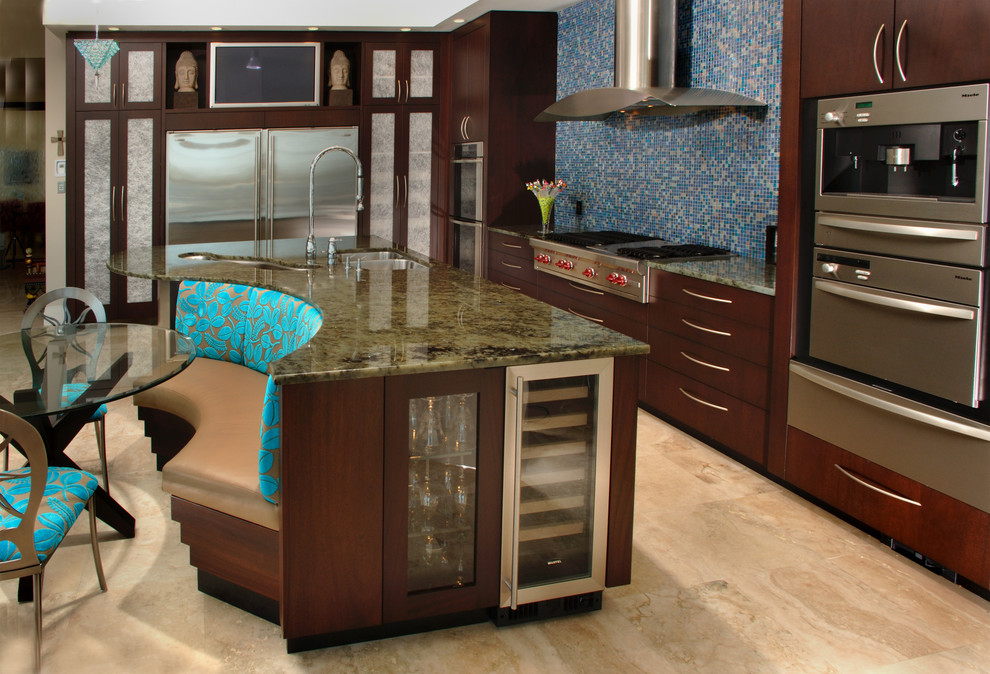 Inspiration for a mid-sized modern l-shaped eat-in kitchen in Tampa with an undermount sink, flat-panel cabinets, dark wood cabinets, granite benchtops, blue splashback, glass tile splashback, stainless steel appliances, travertine floors and with island.