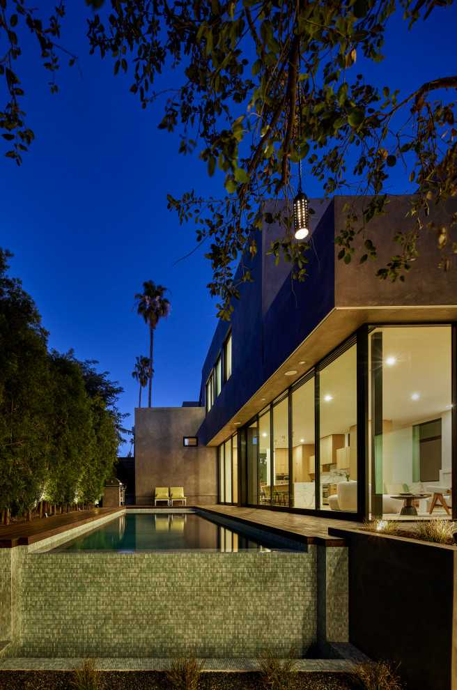 Example of a huge minimalist gray split-level stucco exterior home design in Los Angeles