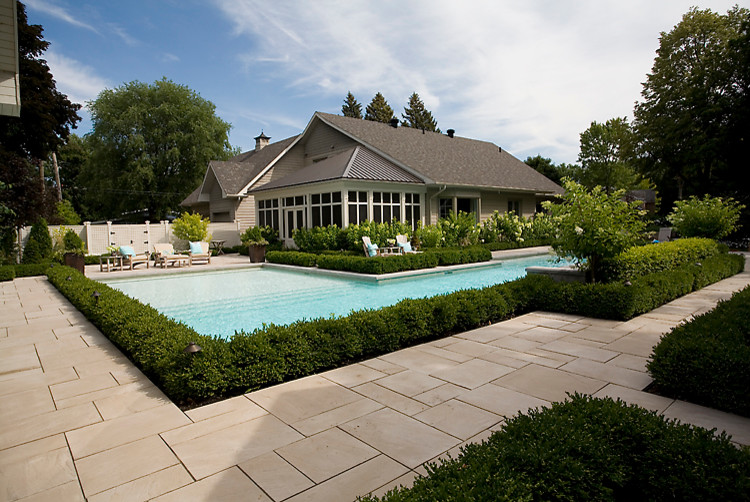 Contemporary backyard rectangular pool in Montreal with concrete pavers.