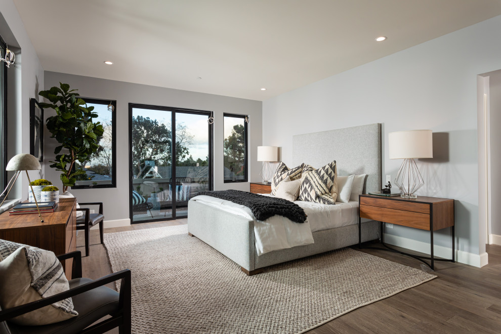 This is an example of a contemporary bedroom in Orange County with grey walls, dark hardwood floors and brown floor.
