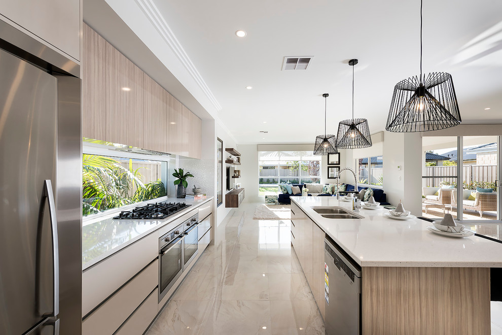 Design ideas for a large contemporary galley open plan kitchen in Perth with a double-bowl sink, medium wood cabinets, quartz benchtops, stainless steel appliances, porcelain floors and with island.