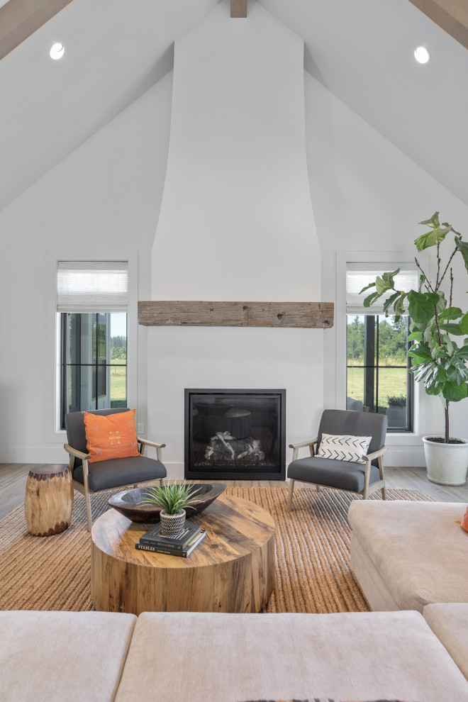 Example of a huge country open concept vinyl floor, brown floor and exposed beam living room library design in Portland with white walls, a standard fireplace, a plaster fireplace and a tv stand