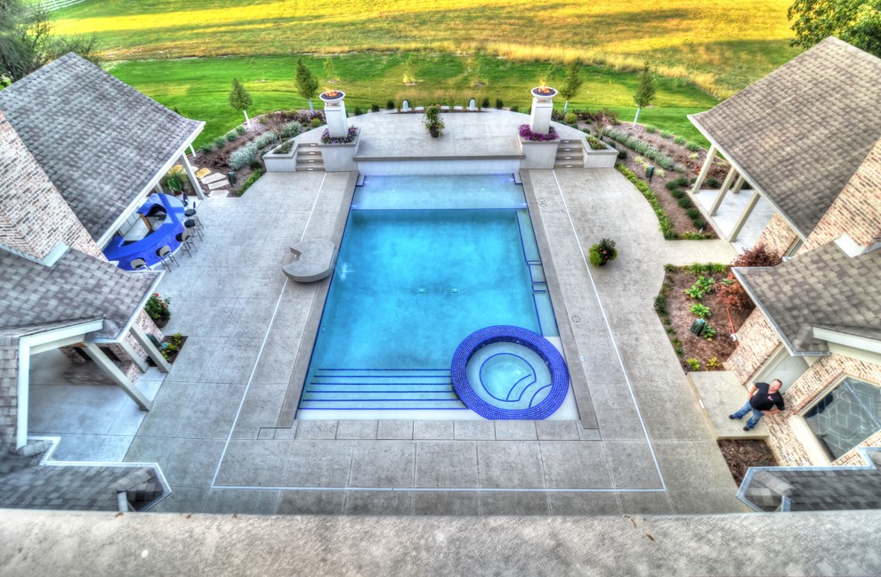 Inspiration for a large transitional backyard concrete paver and rectangular natural hot tub remodel in Cedar Rapids
