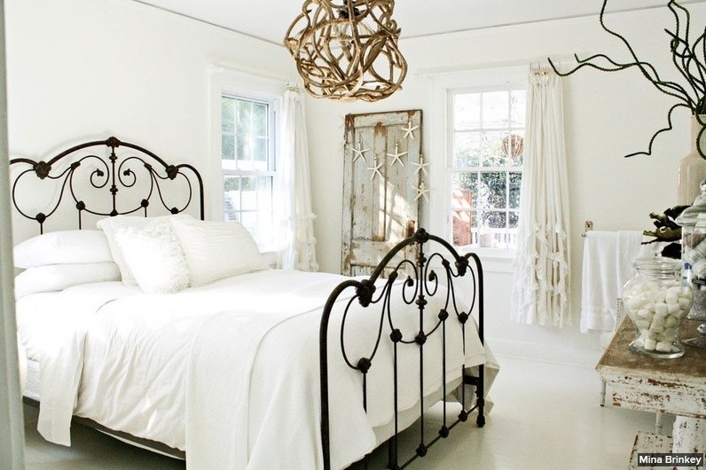 Example of a mid-sized coastal guest painted wood floor bedroom design in Tampa with yellow walls
