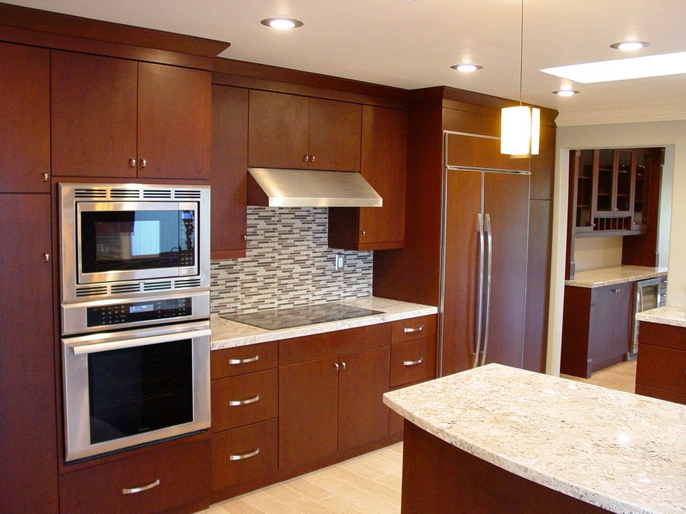 Example of a small transitional u-shaped porcelain tile eat-in kitchen design in San Francisco with an undermount sink, flat-panel cabinets, medium tone wood cabinets, quartz countertops, beige backsplash, porcelain backsplash and paneled appliances