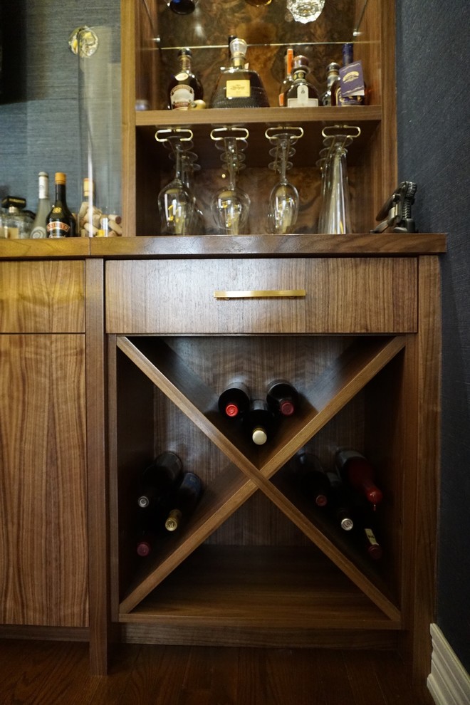 Inspiration for a mid-sized midcentury single-wall seated home bar in Toronto with a drop-in sink, flat-panel cabinets, medium wood cabinets, onyx benchtops, blue splashback and medium hardwood floors.