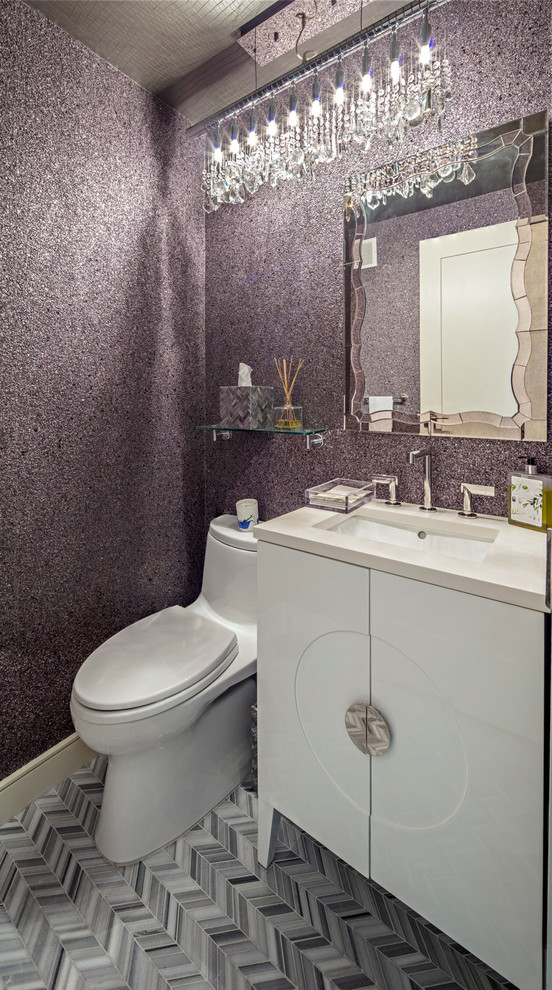 This is an example of a mid-sized modern powder room in New York with purple walls, porcelain floors, flat-panel cabinets, white cabinets, a one-piece toilet, gray tile, white tile, porcelain tile, an undermount sink and engineered quartz benchtops.