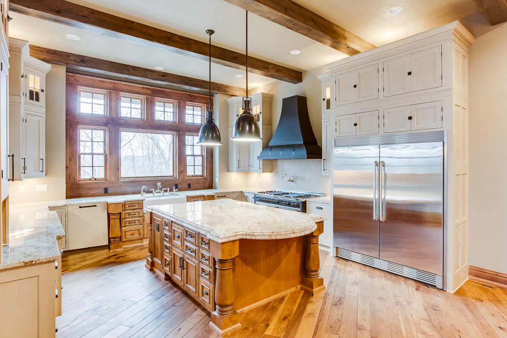 Huge mountain style u-shaped medium tone wood floor eat-in kitchen photo with a farmhouse sink, beaded inset cabinets, beige cabinets, granite countertops, beige backsplash, mosaic tile backsplash, stainless steel appliances and an island