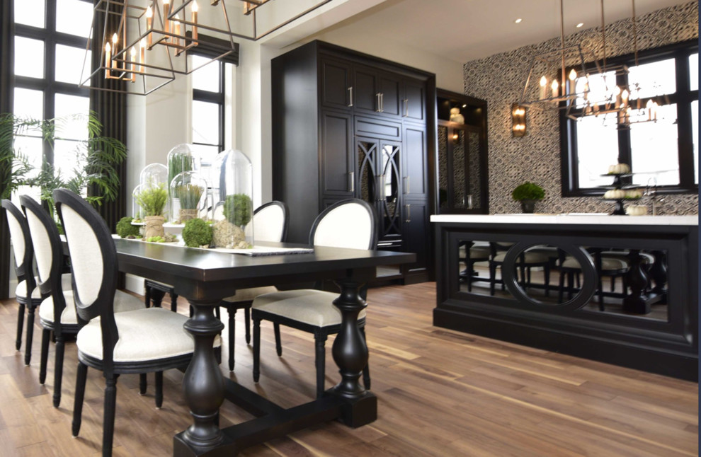 Example of a large transitional l-shaped medium tone wood floor and brown floor eat-in kitchen design with recessed-panel cabinets, an island, an undermount sink, black cabinets, marble countertops, multicolored backsplash, cement tile backsplash and paneled appliances