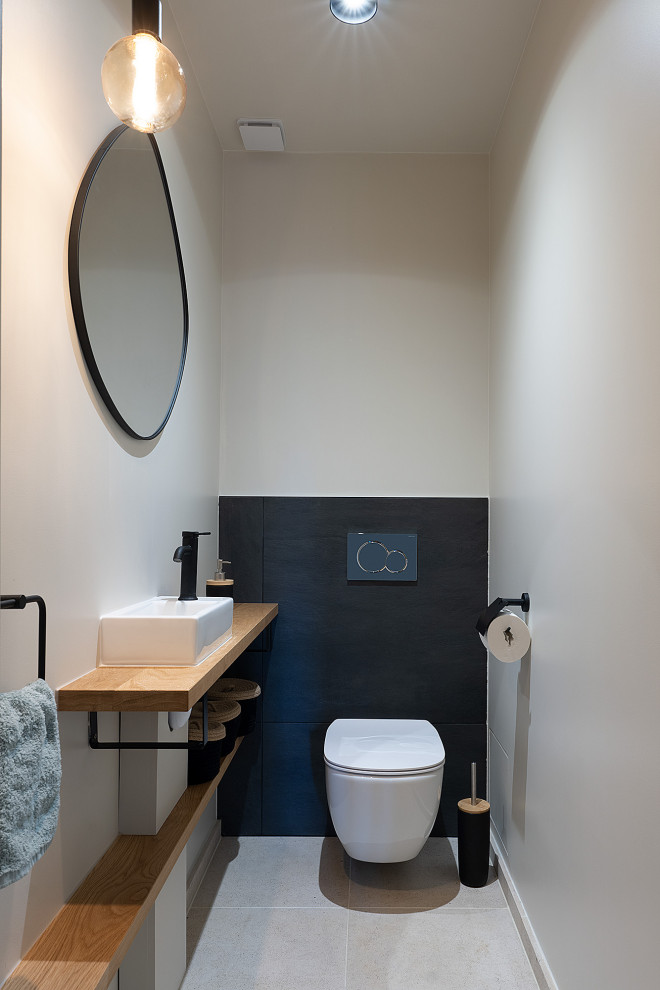 Inspiration for a medium sized contemporary cloakroom in Other with open cabinets, beige cabinets, a wall mounted toilet, grey tiles, slate tiles, white walls, limestone flooring, a vessel sink, wooden worktops, beige floors, beige worktops and a floating vanity unit.