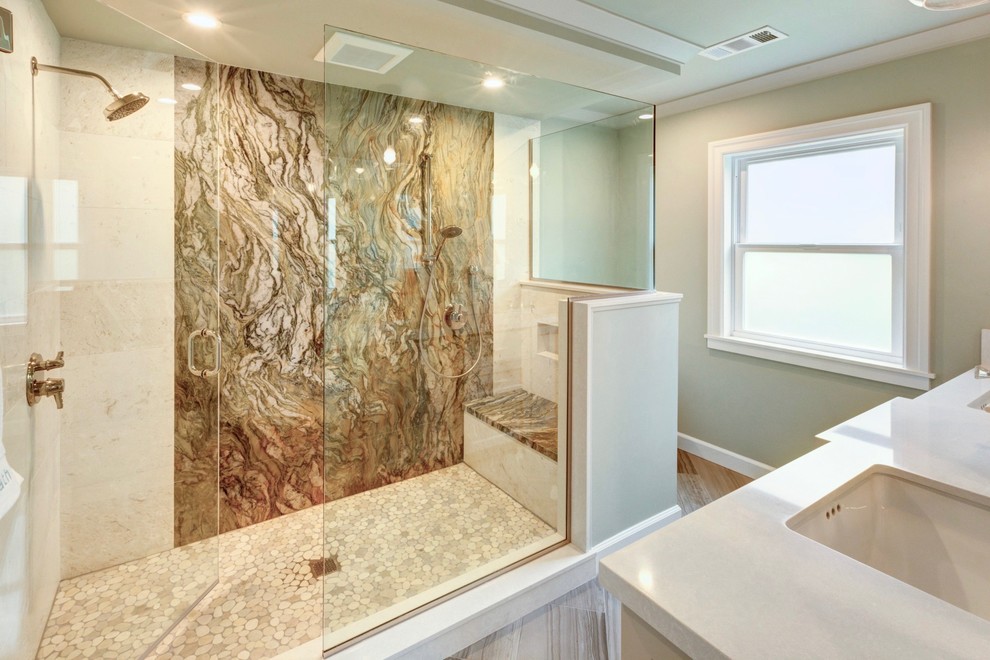 This is an example of a mid-sized transitional bathroom in San Francisco with shaker cabinets, beige cabinets, a double shower, a one-piece toilet, multi-coloured tile, stone slab, green walls, limestone floors, an undermount sink and engineered quartz benchtops.