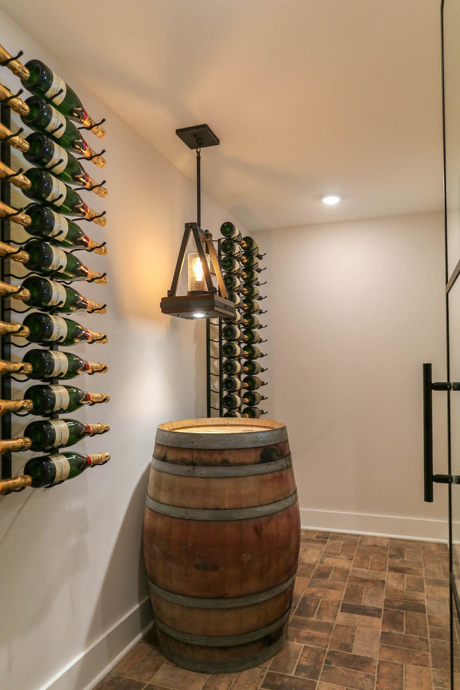 Photo of a mid-sized country wine cellar in Chicago with brick floors, storage racks and beige floor.