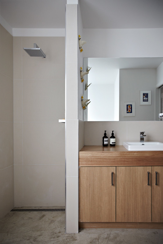 Photo of a small contemporary 3/4 bathroom in Melbourne with medium wood cabinets, wood benchtops, an open shower, a one-piece toilet, white walls and concrete floors.