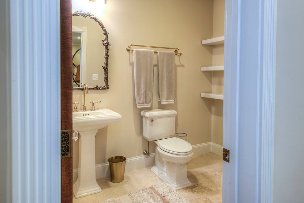 Foto di un bagno di servizio chic di medie dimensioni con WC a due pezzi, pareti beige, parquet scuro, lavabo a colonna e pavimento beige