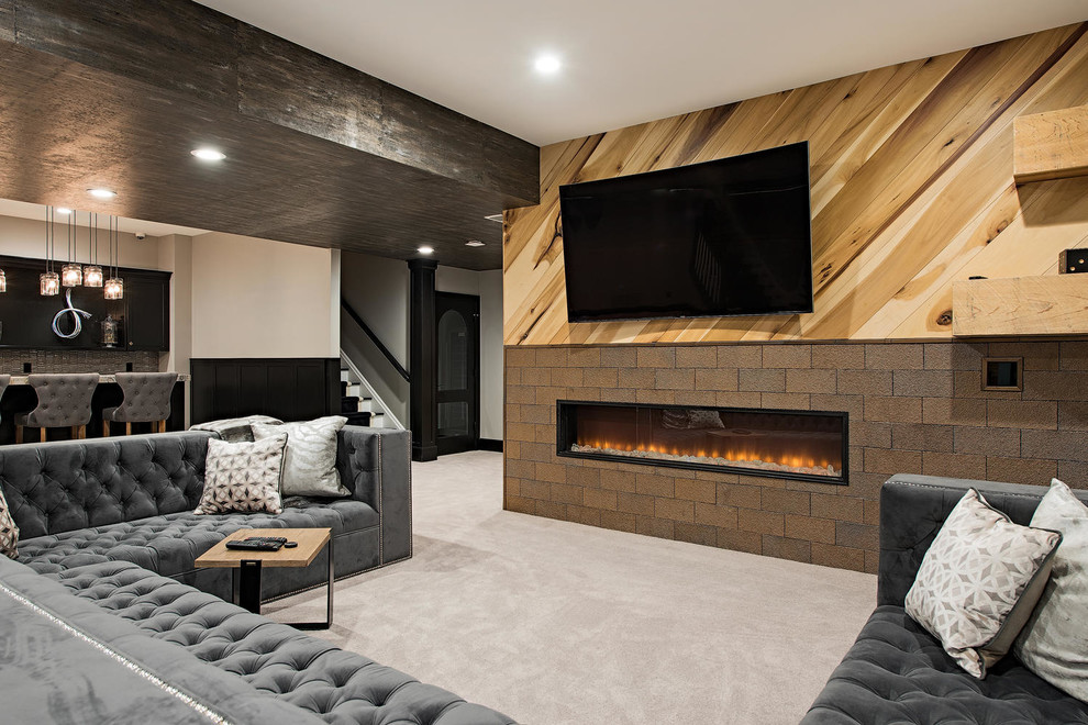 This is an example of a large transitional fully buried basement in Cleveland with a game room, carpet, a ribbon fireplace, grey floor, beige walls and a tile fireplace surround.
