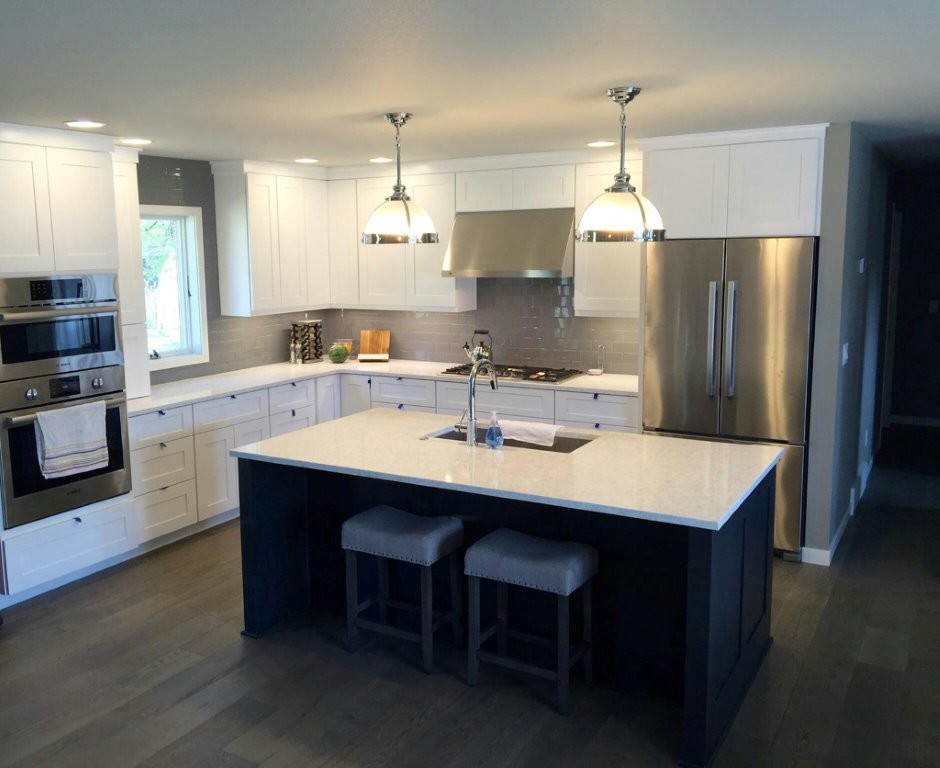 Mid-sized transitional l-shaped dark wood floor open concept kitchen photo with a double-bowl sink, shaker cabinets, white cabinets, gray backsplash, stainless steel appliances, an island and subway tile backsplash