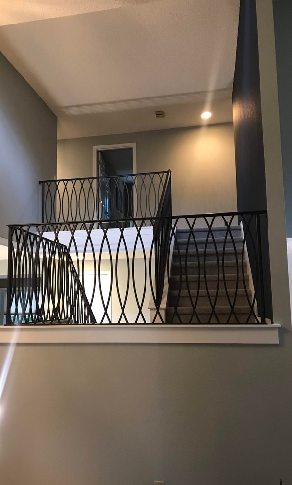 Inspiration for a mid-sized transitional carpeted u-shaped metal railing staircase remodel in Seattle with carpeted risers