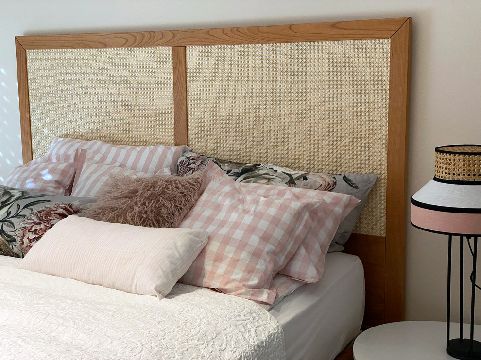 Modelo de dormitorio principal de estilo de casa de campo de tamaño medio con paredes rosas, suelo de madera clara y suelo beige