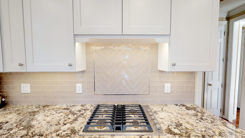 Eat-in kitchen - large transitional l-shaped medium tone wood floor and brown floor eat-in kitchen idea in Raleigh with a double-bowl sink, shaker cabinets, white cabinets, granite countertops, beige backsplash, ceramic backsplash, stainless steel appliances, an island and multicolored countertops