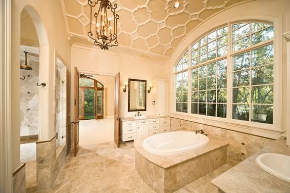 Inspiration for a large contemporary master beige tile and porcelain tile porcelain tile and beige floor drop-in bathtub remodel in Houston with recessed-panel cabinets, white cabinets, beige walls, a drop-in sink, quartzite countertops, a hinged shower door and beige countertops