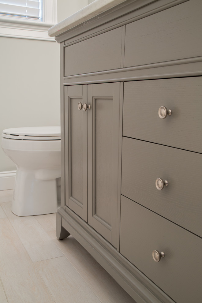 Inspiration for a mid-sized transitional kids bathroom in Boston with grey cabinets, recessed-panel cabinets, white tile, porcelain tile, grey walls, porcelain floors and engineered quartz benchtops.