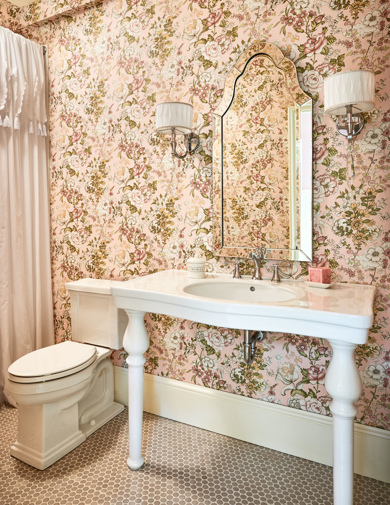 This is an example of a mid-sized traditional 3/4 bathroom in Charlotte with a console sink, a two-piece toilet, pink walls, white cabinets, a drop-in tub, a corner shower, white tile, stone slab, terra-cotta floors, solid surface benchtops and a shower curtain.