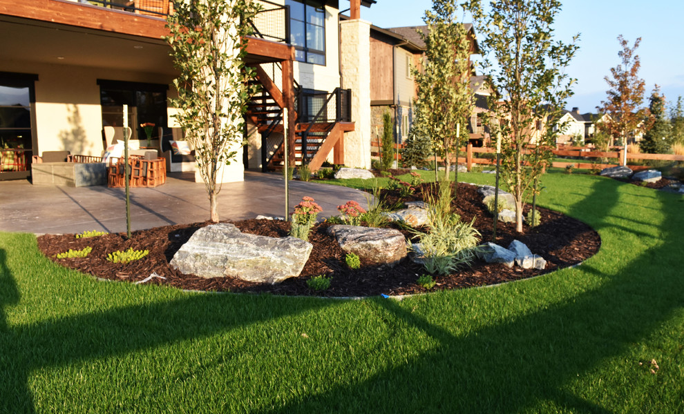 This is an example of a mid-sized transitional full sun backyard concrete paver landscaping.