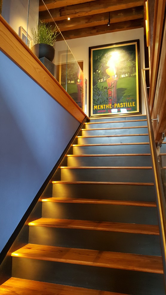 Photo of a medium sized eclectic wood straight staircase in Boston with wood risers.