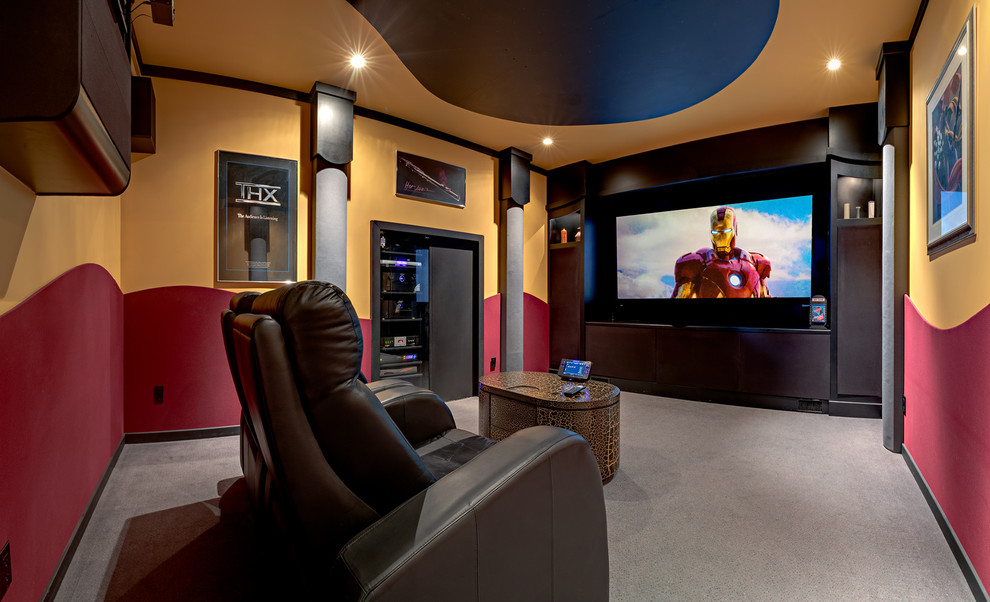 Photo of a mid-sized modern enclosed home theatre in Calgary with multi-coloured walls, carpet and a projector screen.