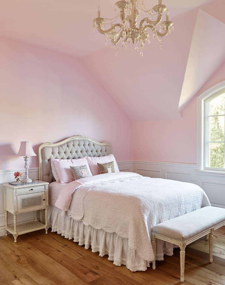 Mediterranean kids' bedroom in Phoenix with pink walls and medium hardwood floors for girls.