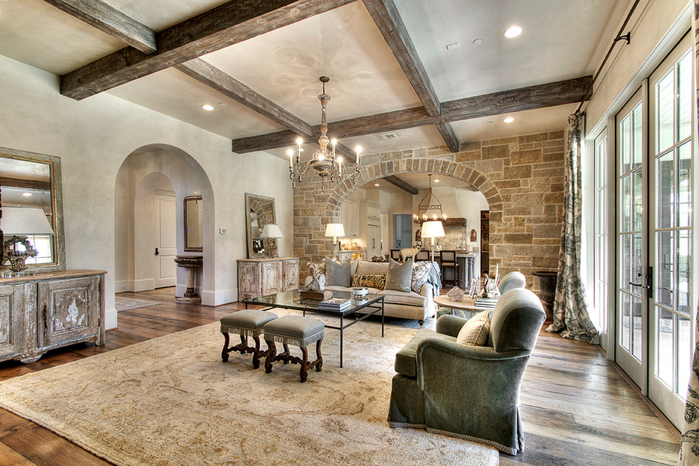 Inspiration for a traditional family room in Houston with beige walls and medium hardwood floors.