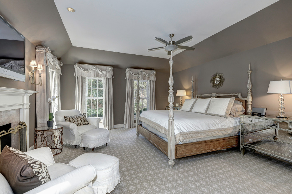 Design ideas for a large traditional master bedroom in DC Metro with brown walls, carpet, a standard fireplace, a stone fireplace surround, beige floor and recessed.