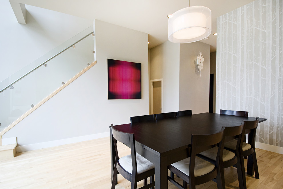 Inspiration for a contemporary dining room in Calgary with grey walls and light hardwood floors.