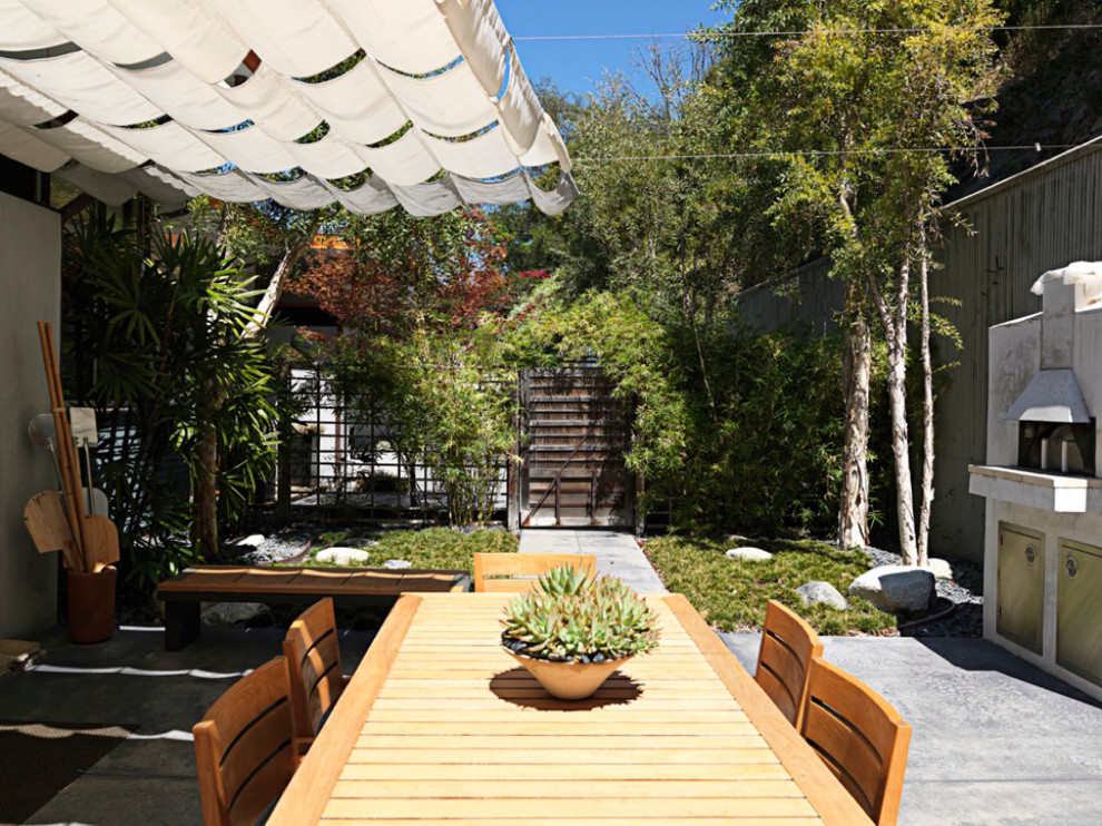 Inspiration for an asian patio in Los Angeles with an awning.