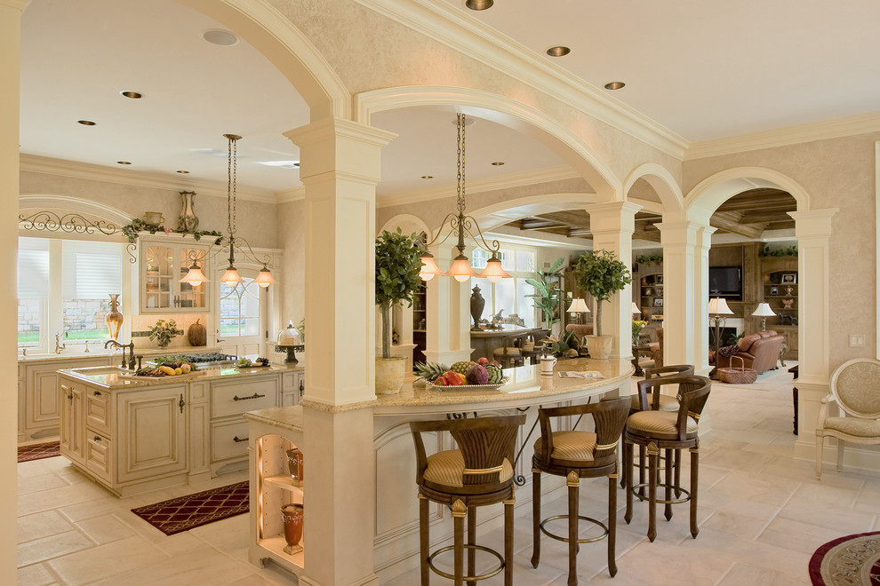 Inspiration for a large mediterranean l-shaped eat-in kitchen in Philadelphia with an undermount sink, beaded inset cabinets, beige cabinets, granite benchtops, beige splashback, ceramic splashback, panelled appliances, porcelain floors, with island and white floor.