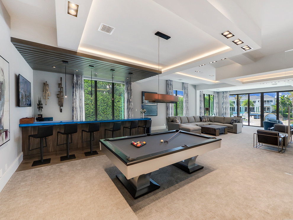 Inspiration for a large contemporary open concept family room in Miami with a game room, grey walls, carpet, no fireplace and no tv.