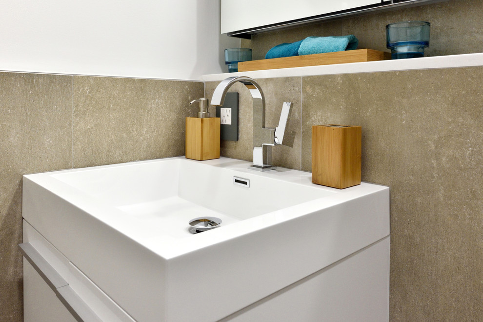 Inspiration for a small contemporary master bathroom in New York with flat-panel cabinets, white cabinets, a drop-in tub, a shower/bathtub combo, a wall-mount toilet, gray tile, ceramic tile, multi-coloured walls, ceramic floors and a wall-mount sink.