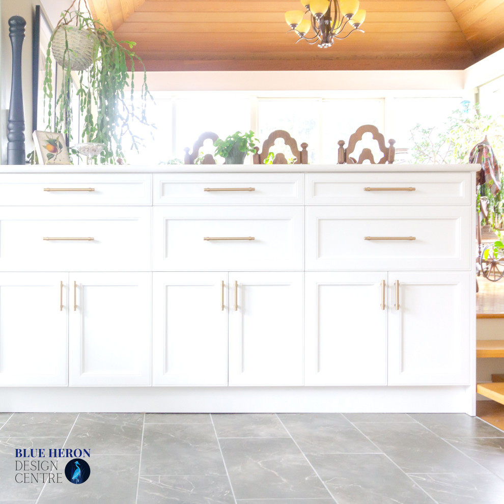 Inspiration for a mid-sized transitional u-shaped laminate floor and gray floor eat-in kitchen remodel with an undermount sink, shaker cabinets, white cabinets, quartz countertops, gray backsplash, ceramic backsplash, white appliances, no island and white countertops