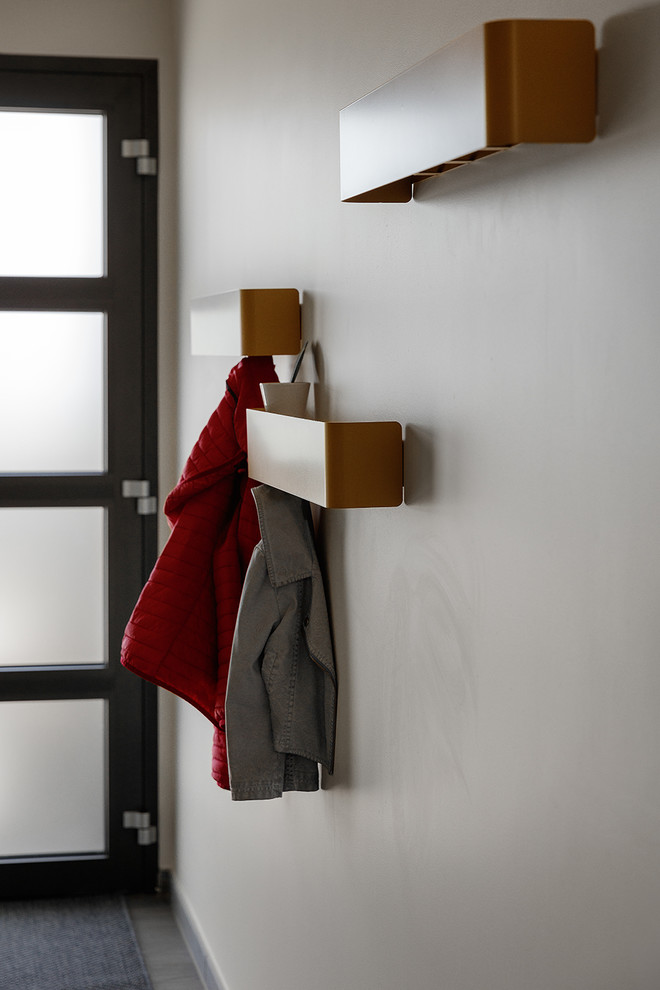 Example of a trendy entryway design with yellow walls