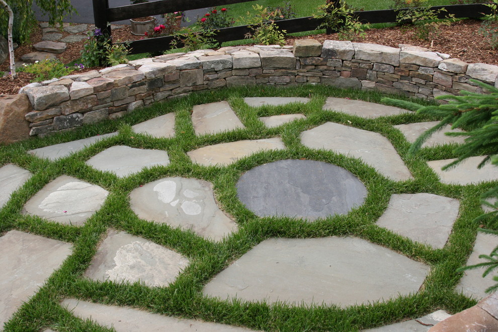 Design ideas for a mid-sized contemporary backyard patio in DC Metro with natural stone pavers.