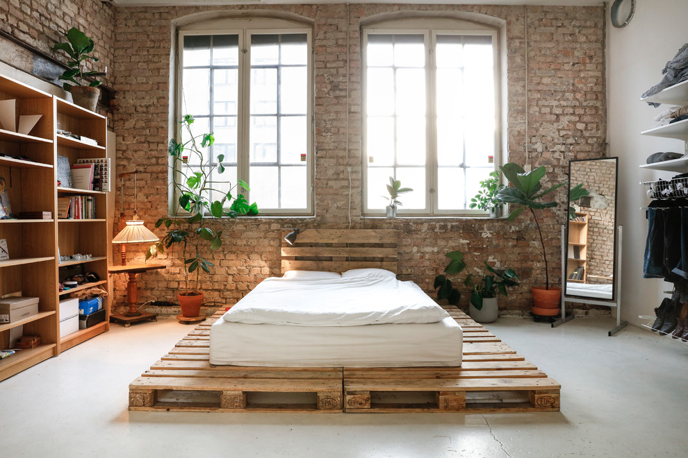 Example of an urban master concrete floor and gray floor bedroom design in Other with multicolored walls