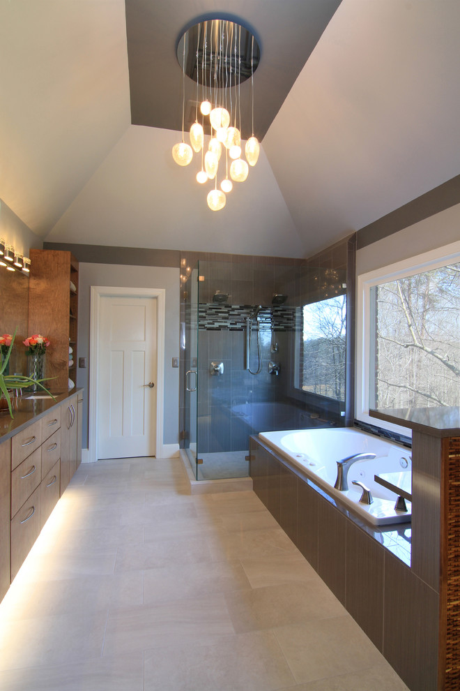 Photo of a large contemporary master bathroom in Other with flat-panel cabinets, medium wood cabinets, a drop-in tub, a corner shower, a two-piece toilet, gray tile, ceramic tile, grey walls, ceramic floors, an undermount sink and engineered quartz benchtops.