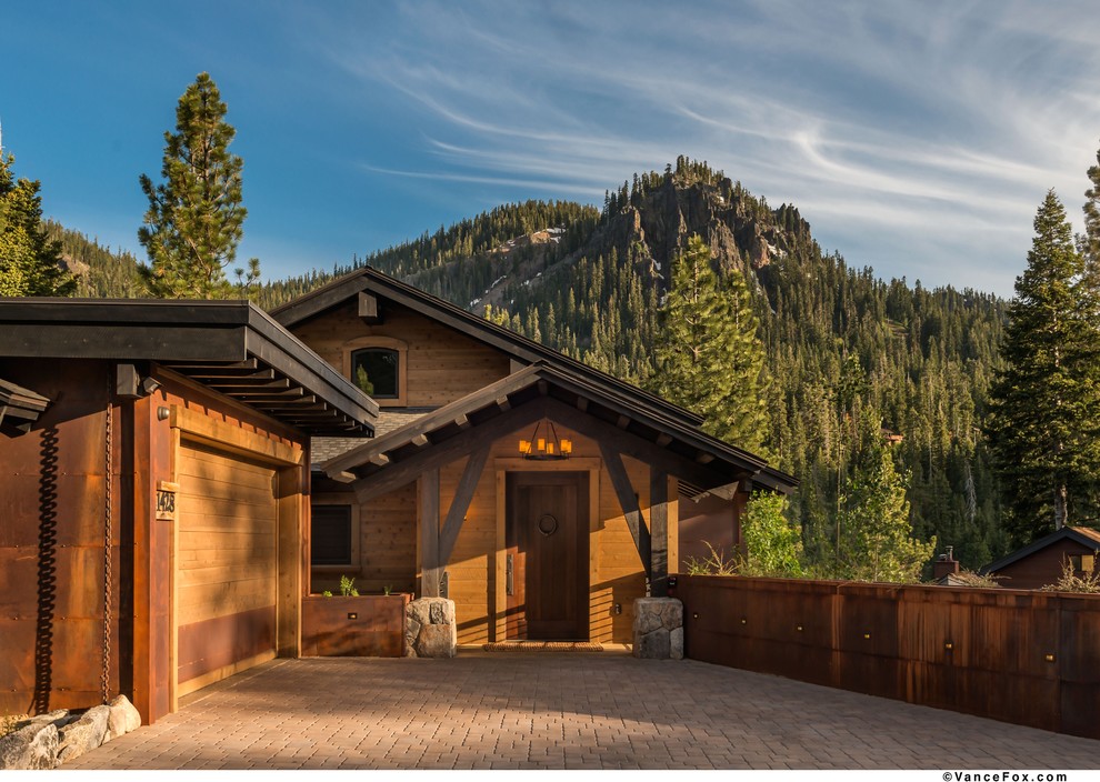 Example of a mountain style front door design with a dark wood front door