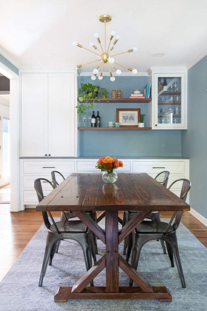 Inspiration for a mid-sized transitional u-shaped light wood floor and brown floor eat-in kitchen remodel in Austin with an undermount sink, shaker cabinets, white cabinets, quartz countertops, blue backsplash, glass tile backsplash, stainless steel appliances, no island and gray countertops