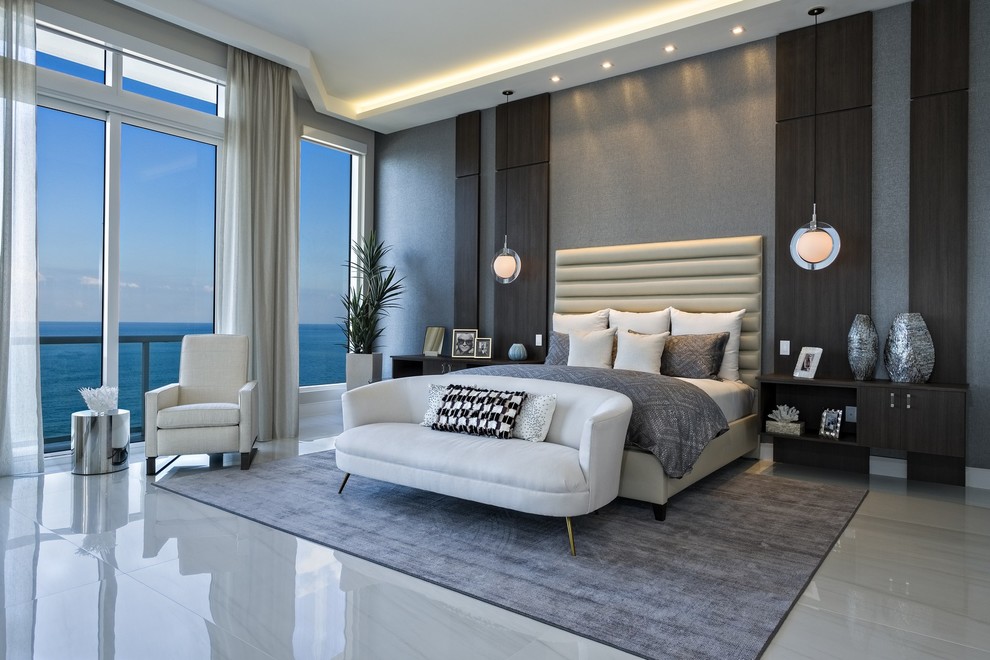 Inspiration for a large contemporary master bedroom in Miami with grey walls and marble floors.