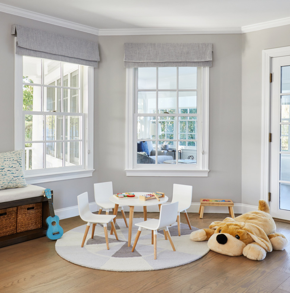 Mid-sized beach style gender-neutral medium tone wood floor playroom photo in New York with gray walls