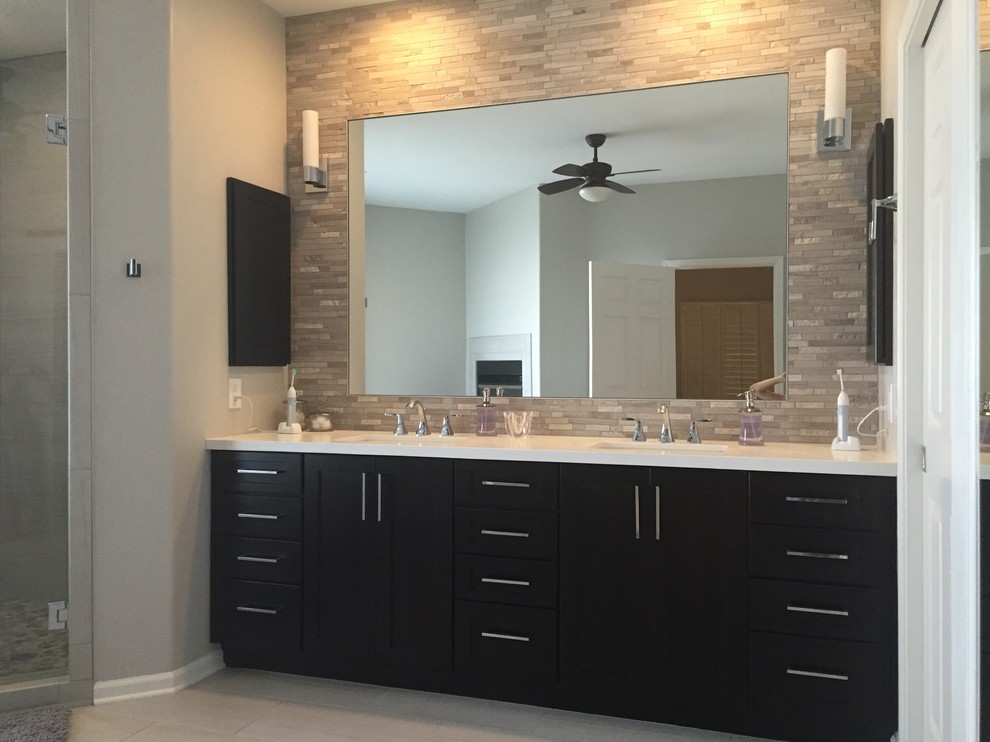 Photo of a large contemporary master bathroom in Phoenix with an undermount sink, shaker cabinets, dark wood cabinets, engineered quartz benchtops, a freestanding tub, a corner shower, gray tile, stone tile, grey walls and porcelain floors.